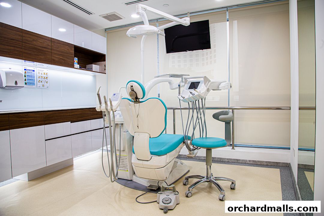 A modern dental clinic examination room with a dental chair and equipment.