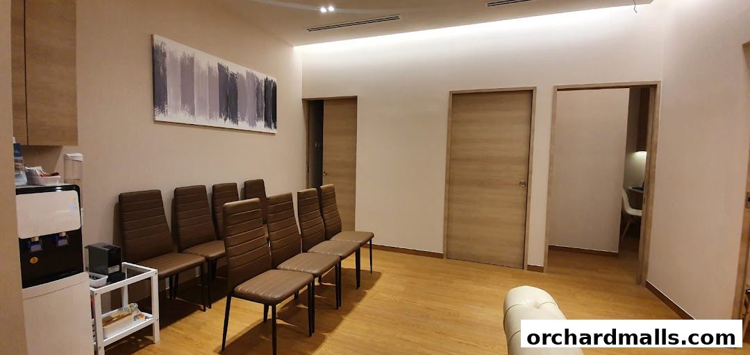 A waiting area with chairs, a water dispenser, and artwork.
