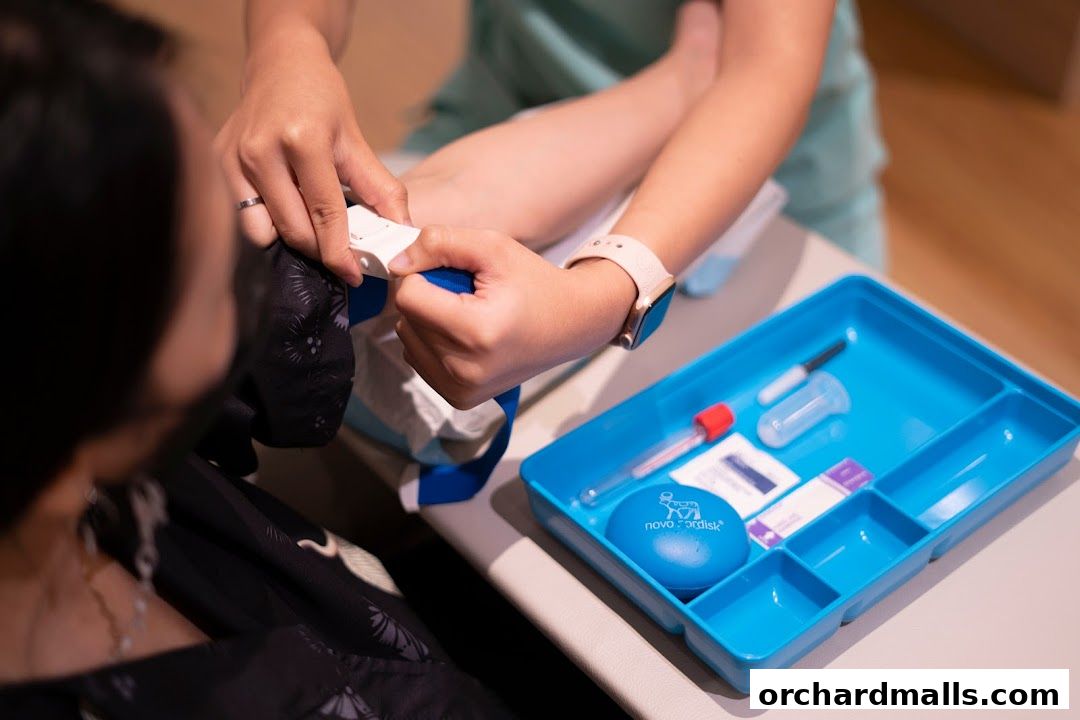 Medical professional applying a tourniquet to a patient's arm for a blood draw.