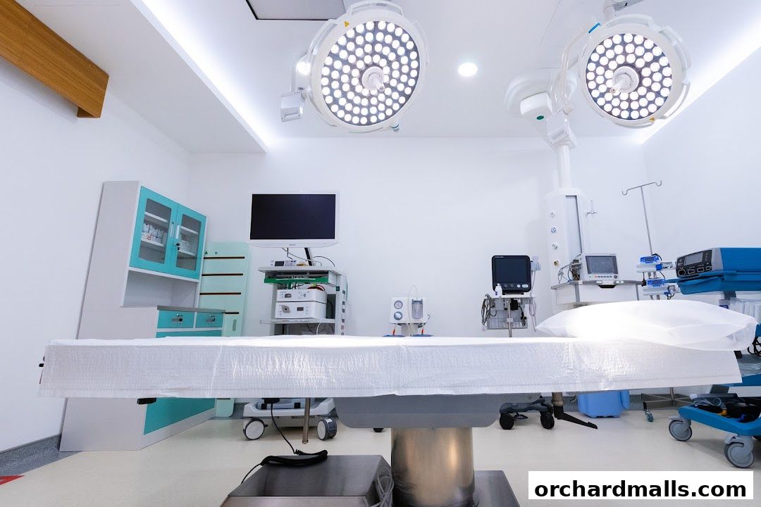A modern operating room with surgical lights, a patient table, and medical equipment.