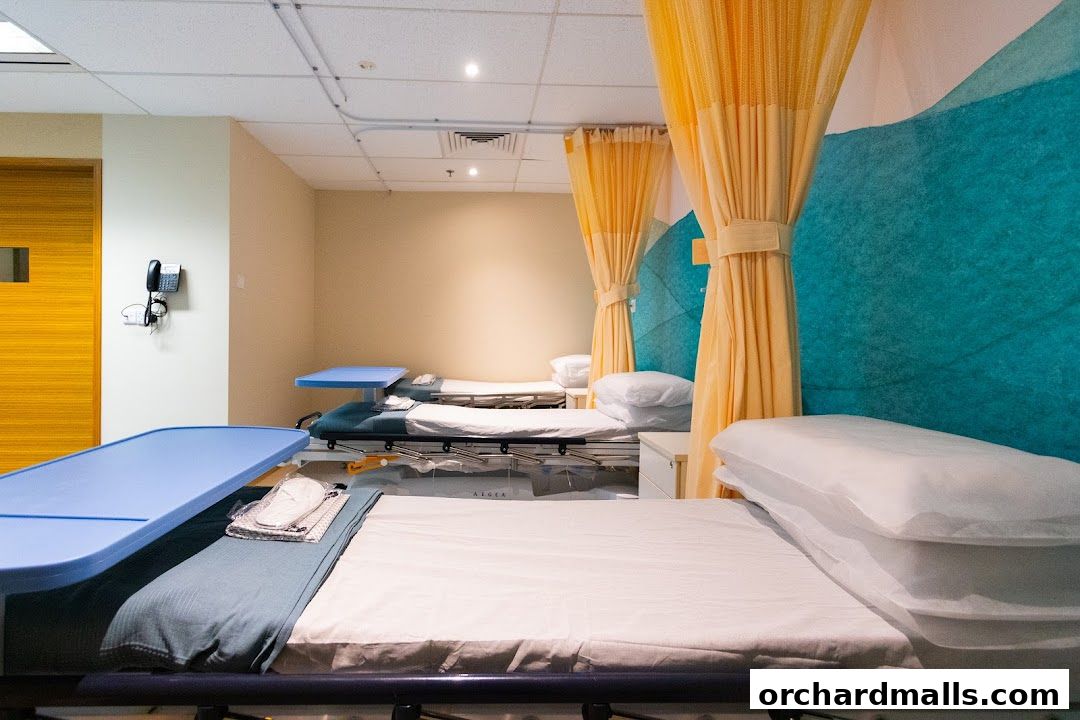 Interior view of a medical facility with multiple beds and privacy curtains.