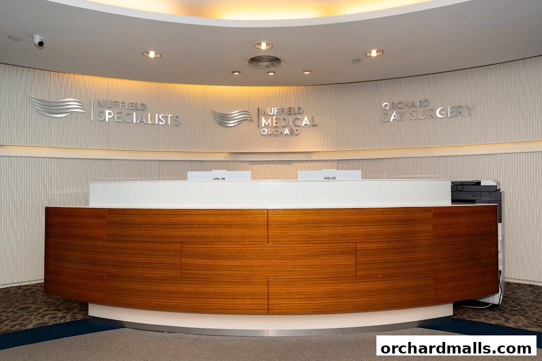 The reception area of Nuffield Medical Orchard, featuring a modern wooden reception desk.