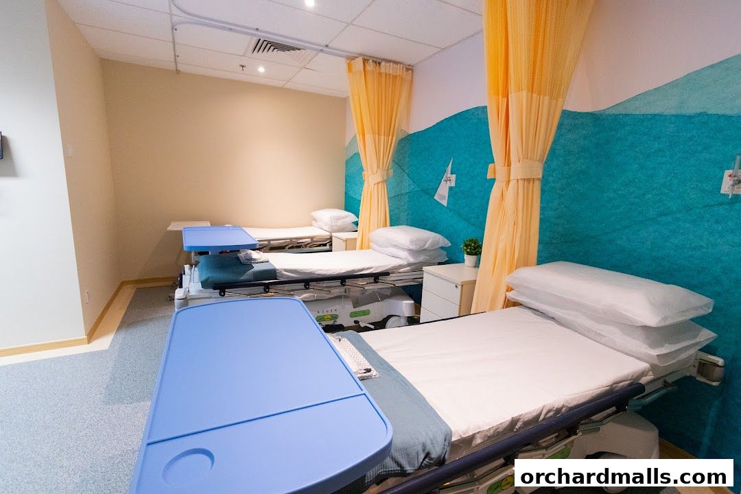 A clean and modern hospital room with three beds and blue medical trays.