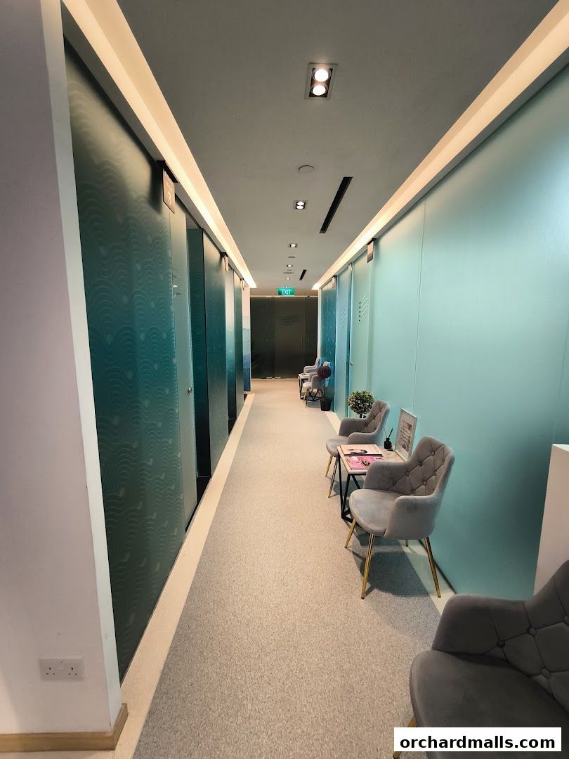 A clean and modern hallway with private rooms and a waiting area.