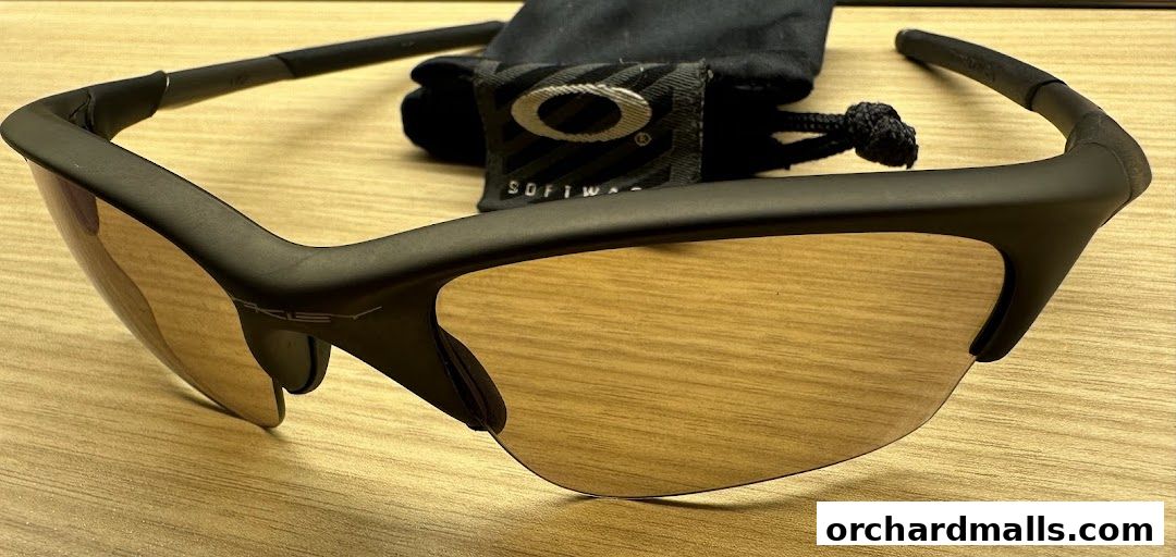 Close-up of Oakley sunglasses with a soft case in the background.