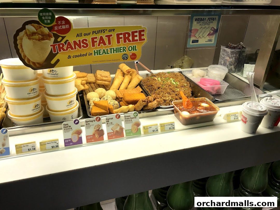 A display case filled with various fried snacks and dishes from Old Chang Kee.