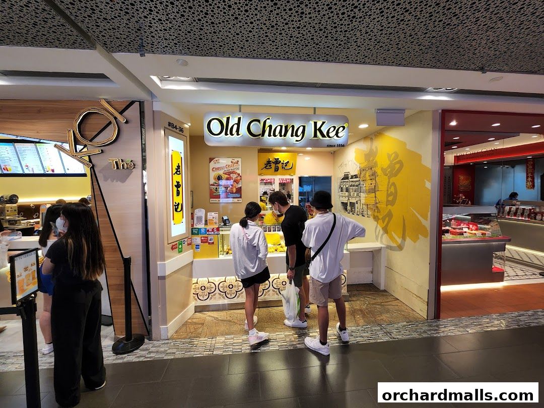 People queuing at the Old Chang Kee shop entrance, with a neighboring shop visible.