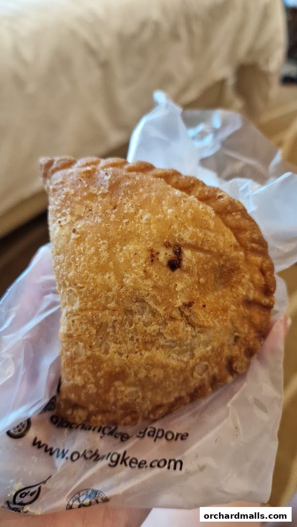 A close-up shot of a golden-brown, crispy pastry from Old Chang Kee.
