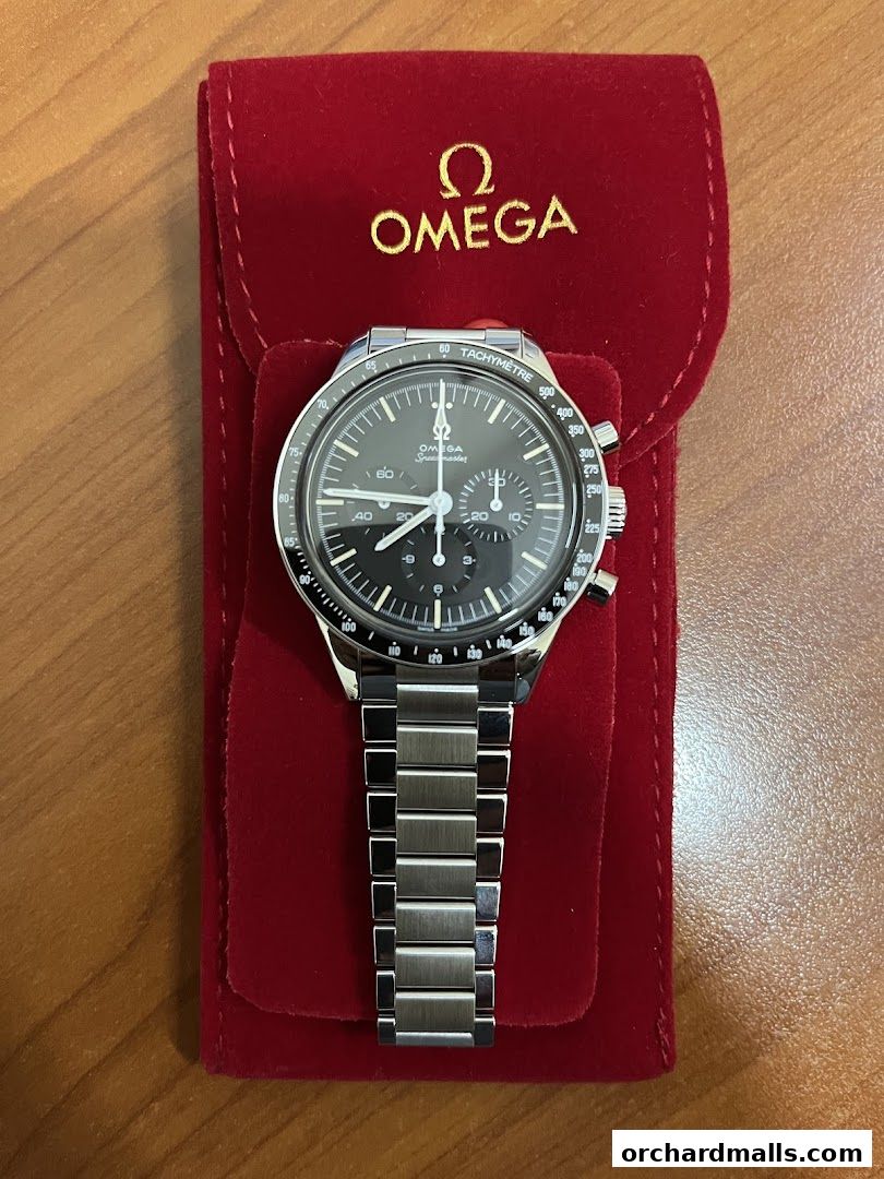 An OMEGA Speedmaster watch displayed in a red velvet pouch.
