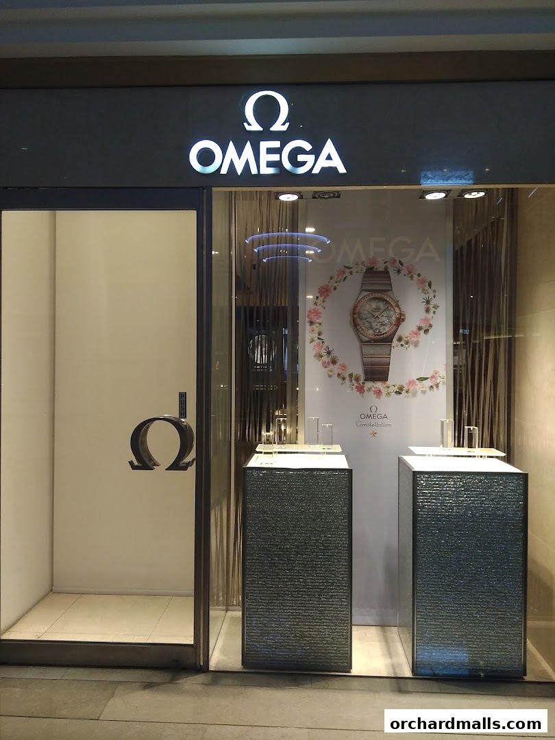 The OMEGA watch shop features a prominent logo and a display window showcasing a watch.