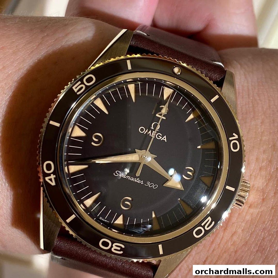 Close-up of an OMEGA Seamaster 300 watch on a wrist with a brown leather strap.