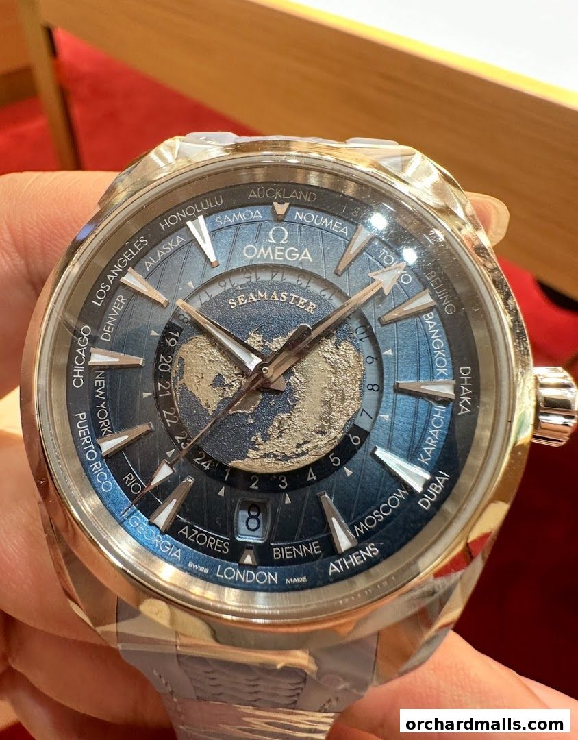 Close-up of an OMEGA Seamaster watch with a world map dial and city time zones.