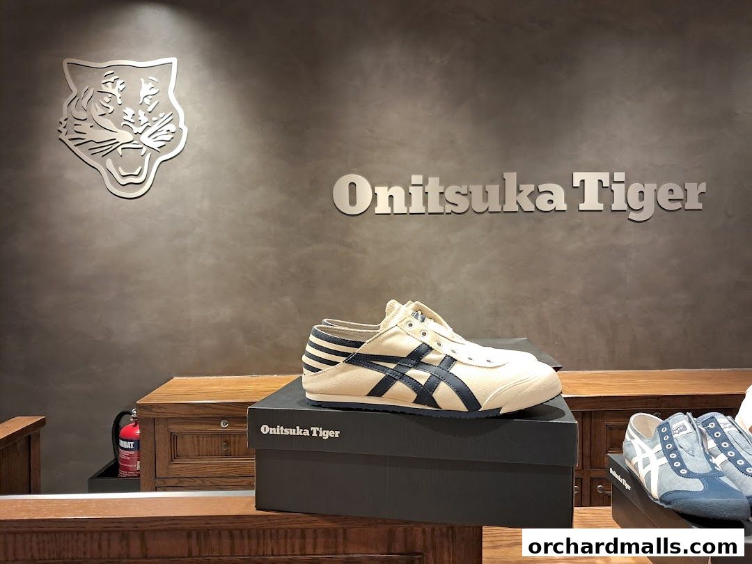 Onitsuka Tiger store interior with shoes displayed on boxes and shelves.