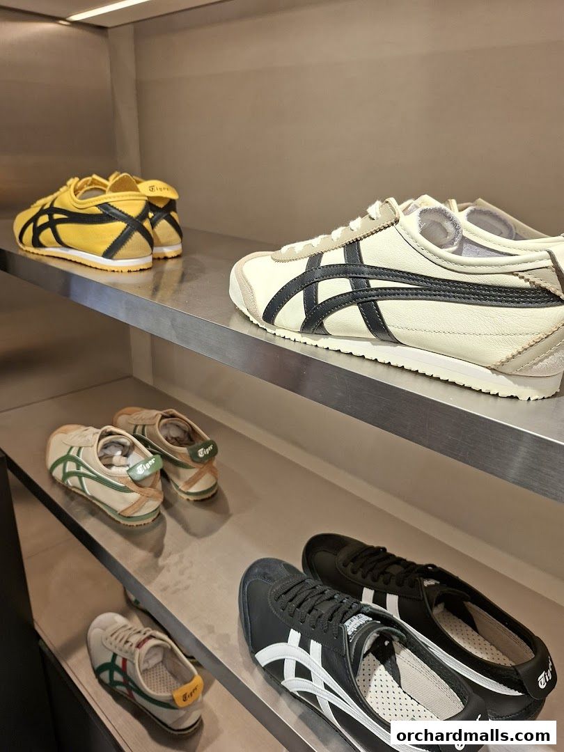 Onitsuka Tiger sneakers displayed on shelves in various colors and styles.