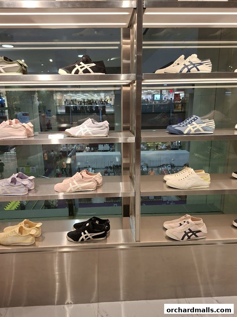 Shelves display a variety of Onitsuka Tiger sneakers in different colors and styles.