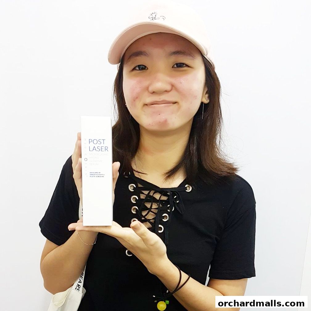 A young woman holds a bottle of 'Post Laser Hydro Glowing Serum' from Only Aesthetics.