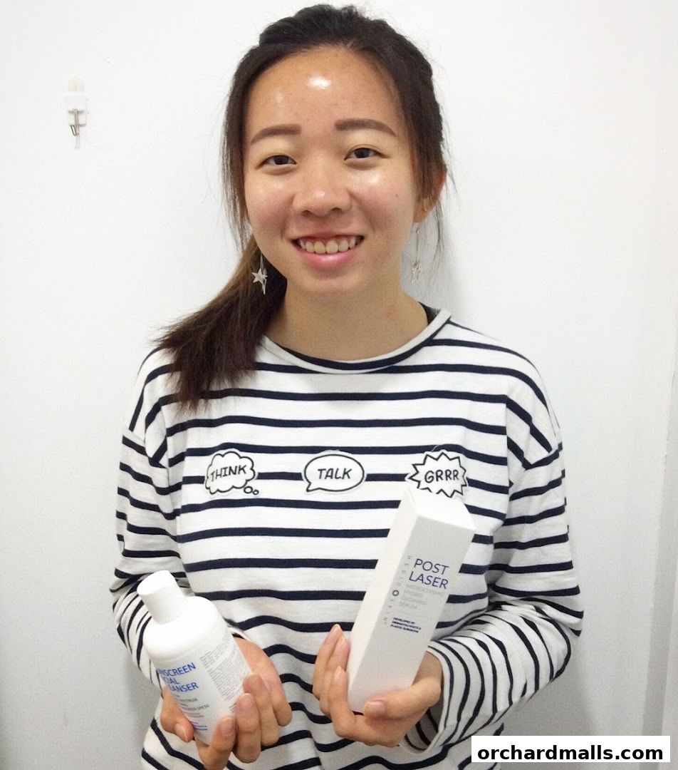 A smiling woman holds skincare products from Only Aesthetics.