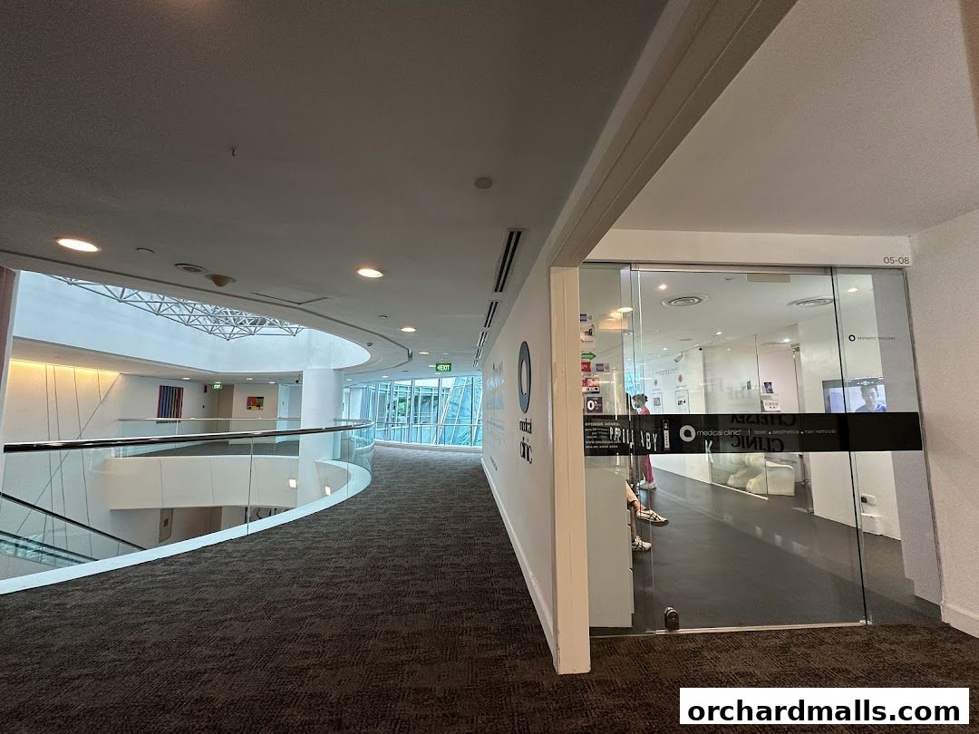 Entrance to a modern aesthetic clinic with glass doors and signage.