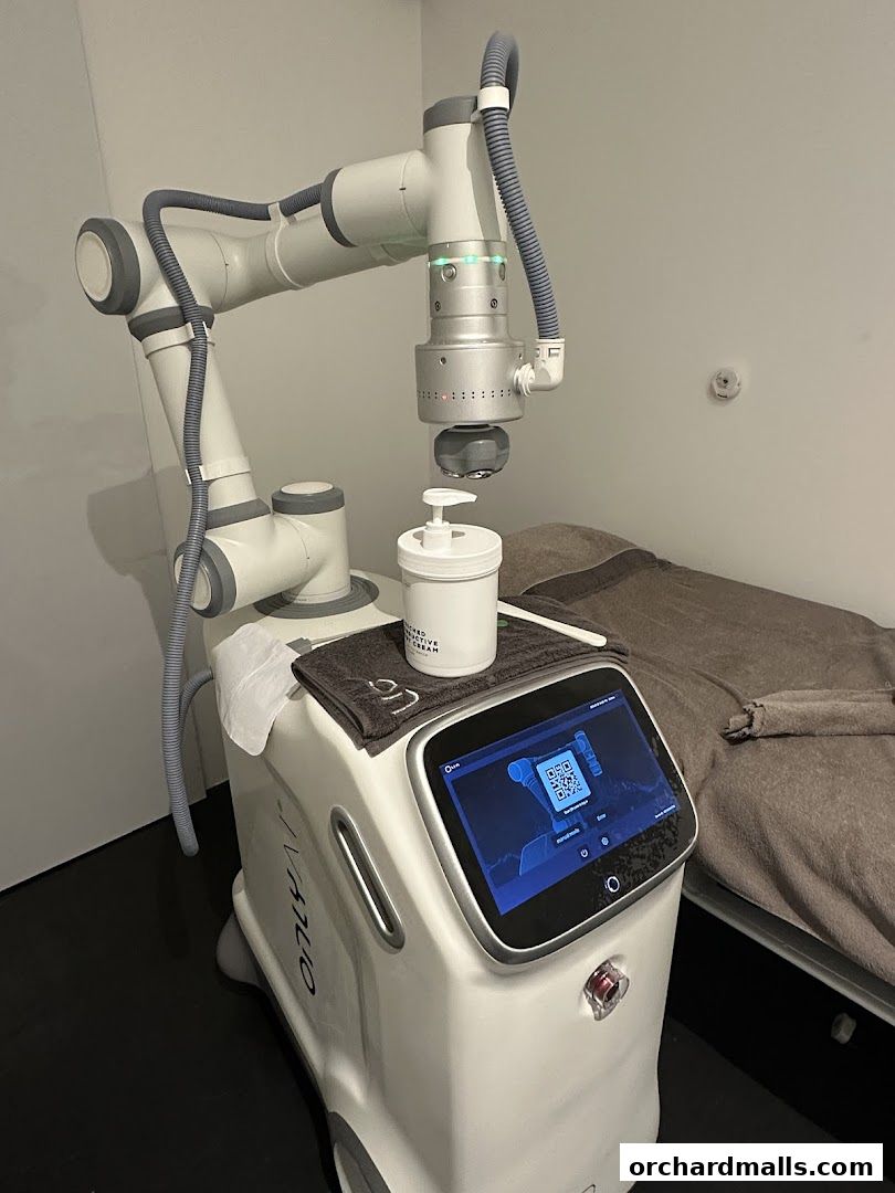 A robotic arm and aesthetic treatment machine with a screen displaying a QR code.