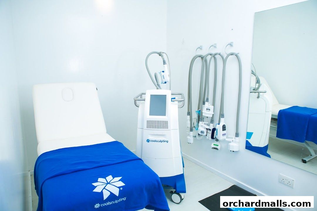 A treatment room with a CoolSculpting machine, examination bed, and applicators.