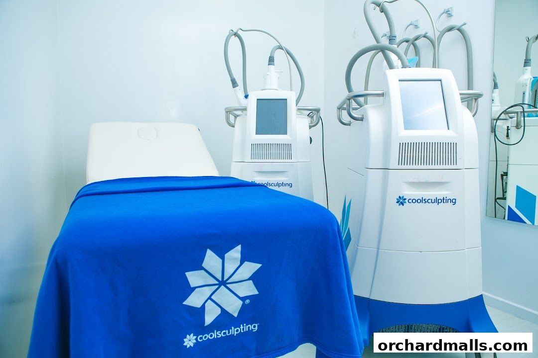 A treatment room with a medical bed and two CoolSculpting machines.