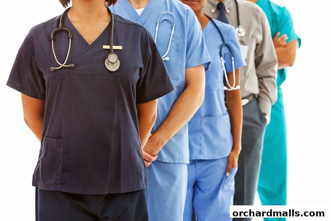 A diverse group of medical professionals in scrubs and uniforms stand in a line.