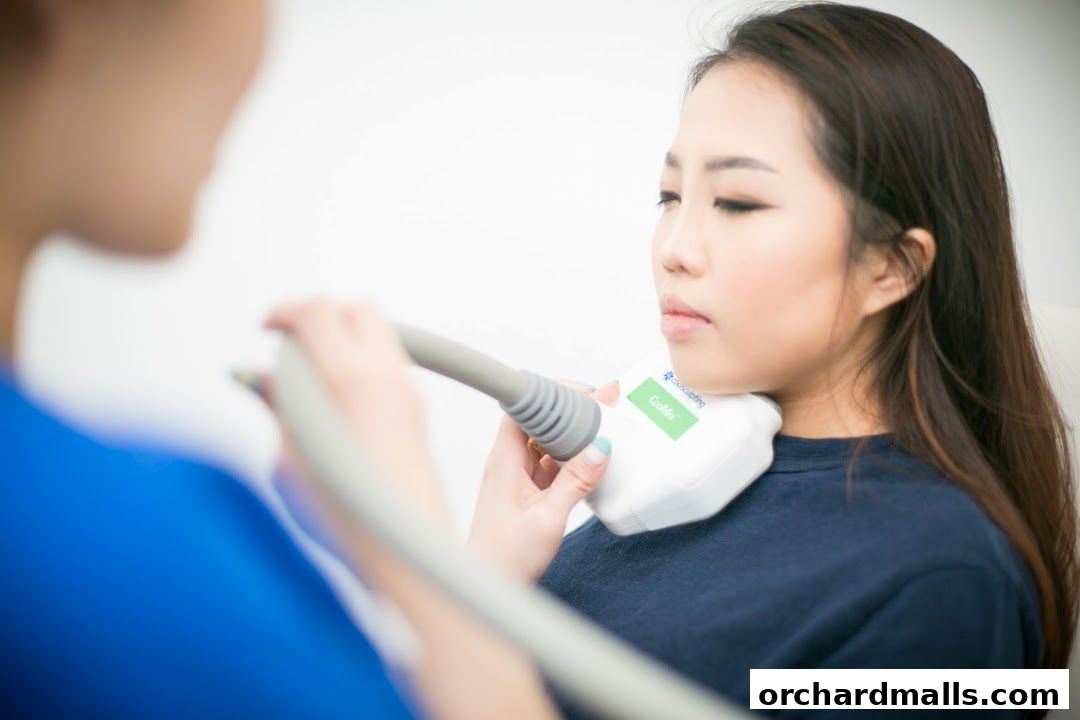 Aesthetician performing a CoolMini treatment on a client's chin area.