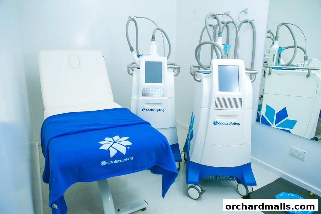 A treatment room with a medical bed and two CoolSculpting machines.