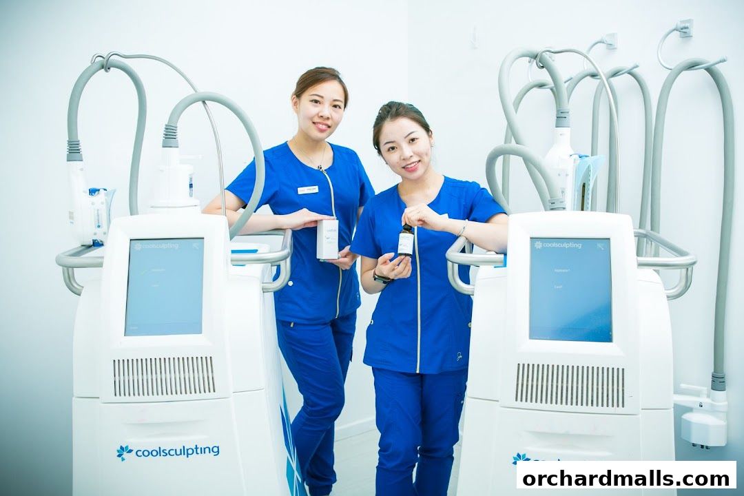 Two smiling women in blue scrubs stand next to CoolSculpting machines, holding product bottles.