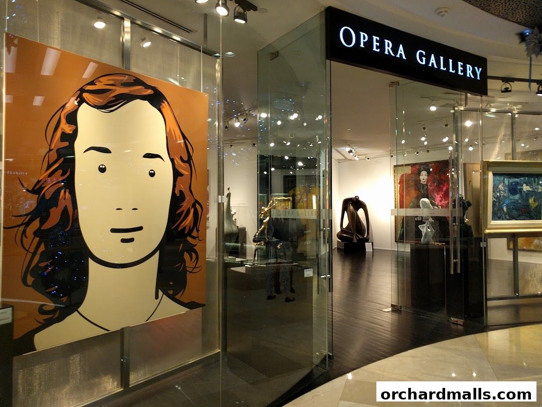The entrance to Opera Gallery Singapore, showcasing modern art and sculptures.
