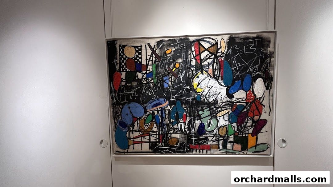 A vibrant abstract painting with bold colors and dynamic lines is displayed on a white wall.