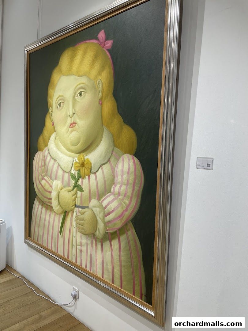 A framed painting of a plump girl with blonde hair holding a yellow flower.