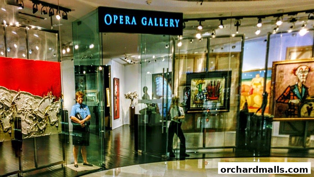 Opera Gallery Singapore showcases diverse artworks, including paintings and sculptures, with staff present.