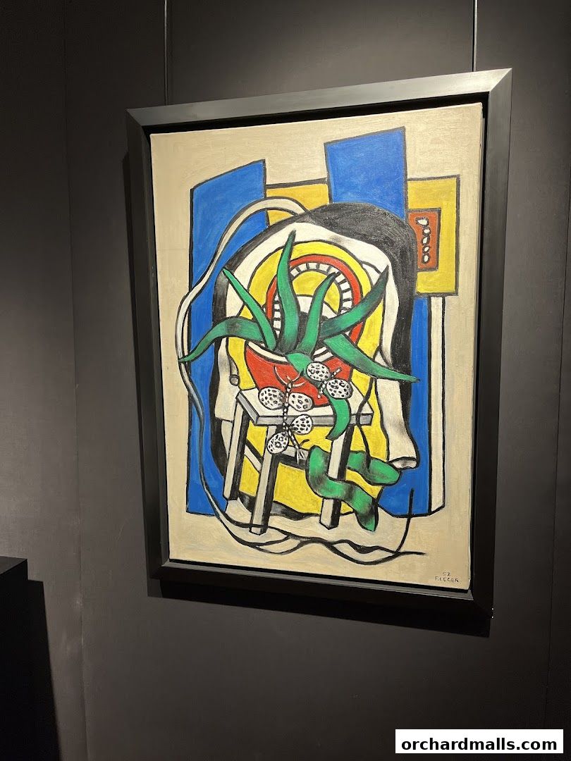 A framed painting with bold colors and abstract shapes, featuring a plant and other objects.
