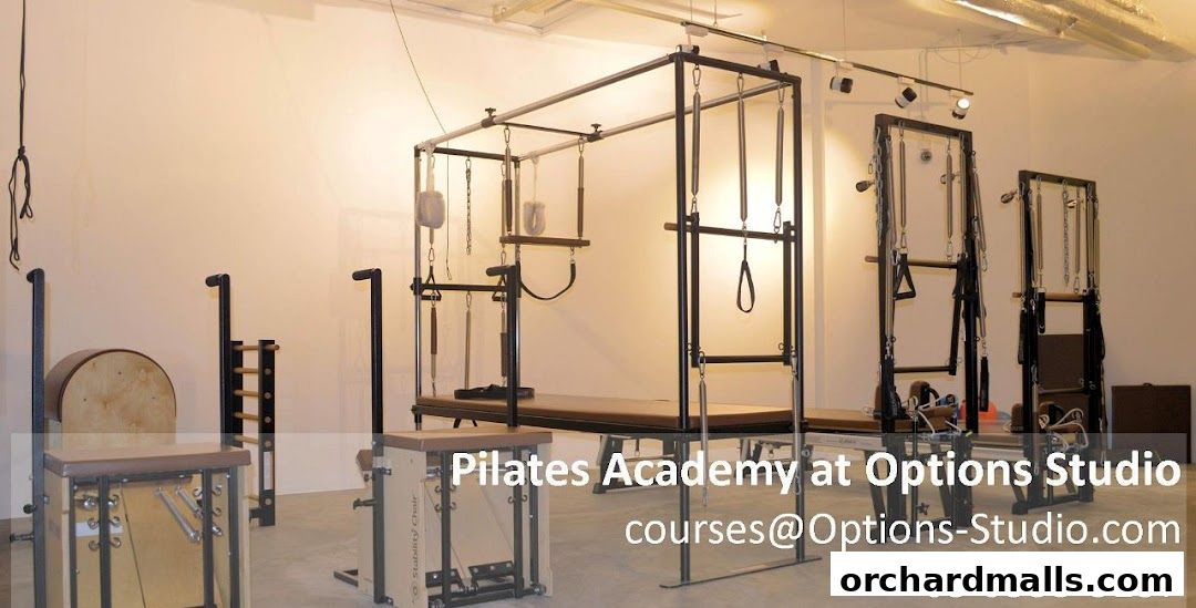 Interior of Options Pilates Studio featuring various Pilates equipment like reformers and chairs.