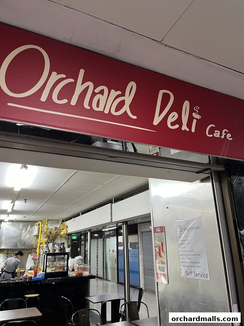 The entrance to Orchard Deli Cafe with its prominent red sign and interior view.