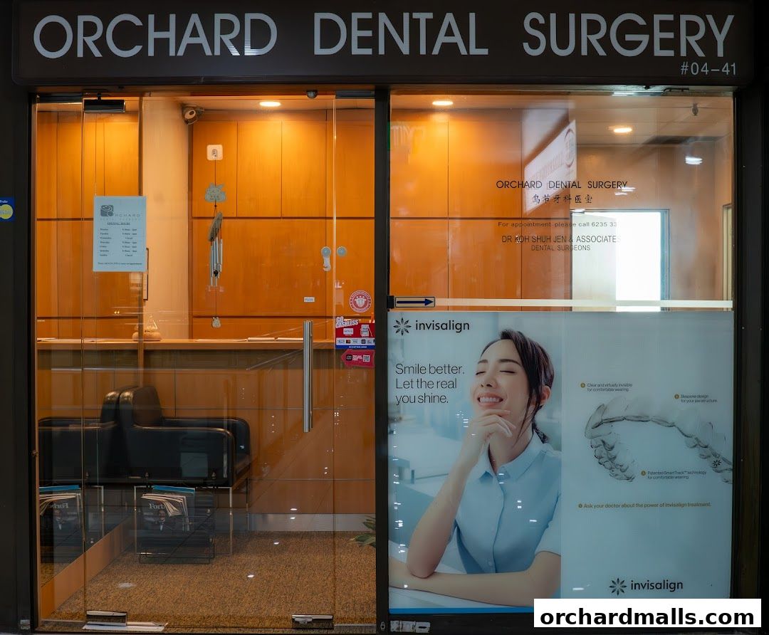 Exterior of Orchard Dental Surgery with a sign and an Invisalign advertisement.