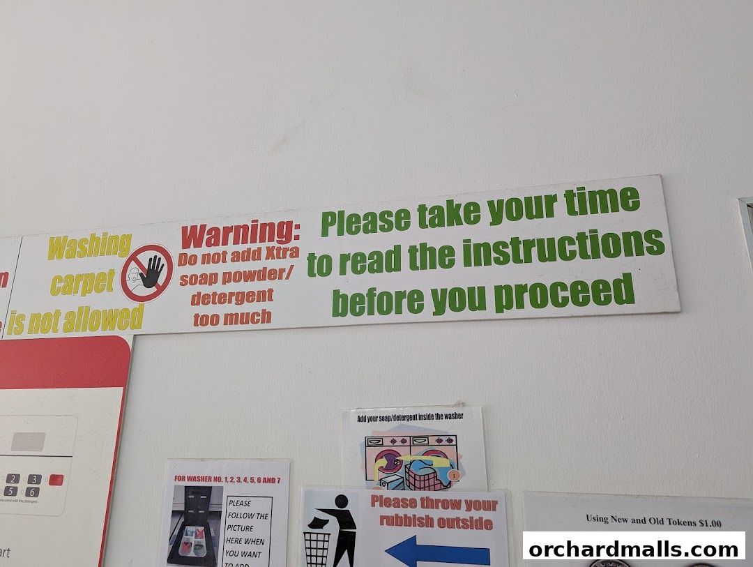 Signs with instructions and warnings for a laundromat, including soap usage and carpet washing.
