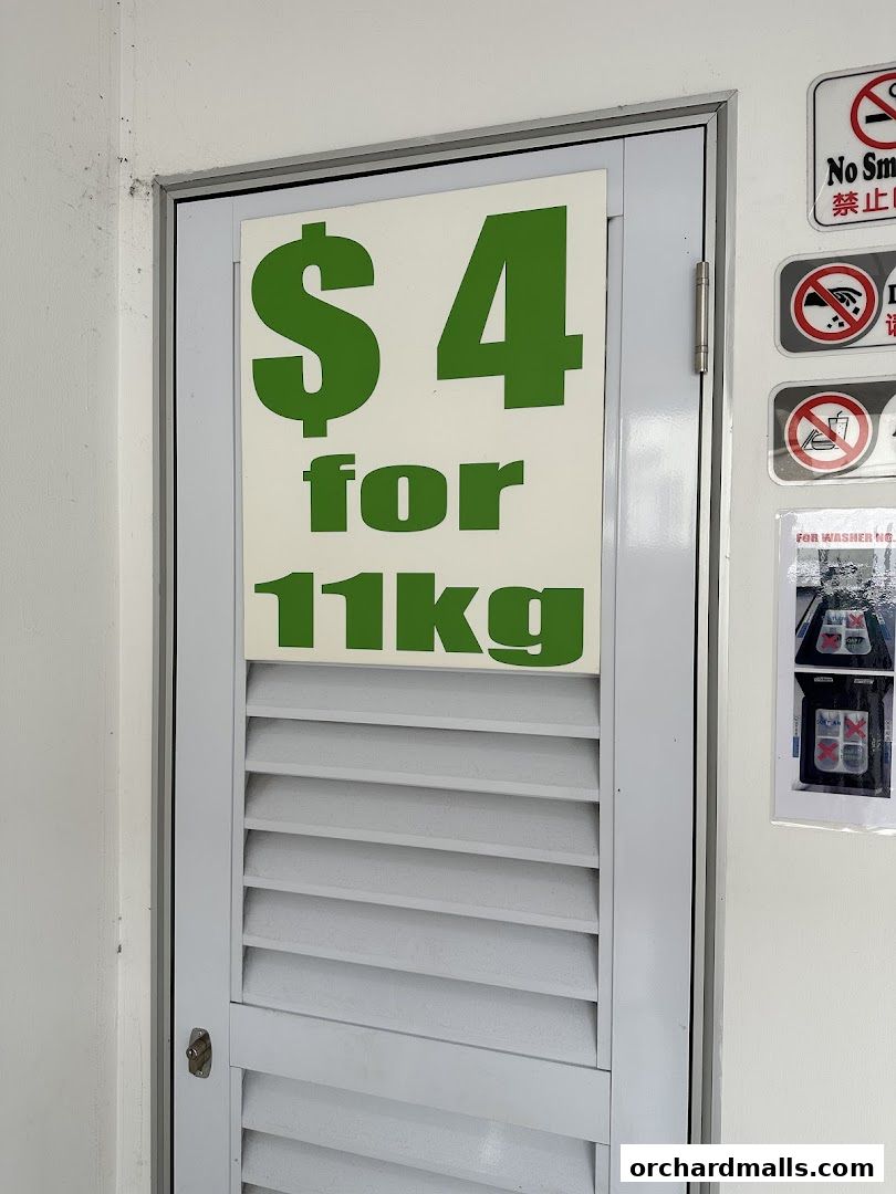 A sign on a louvered door advertises laundry services for $4 for 11kg.