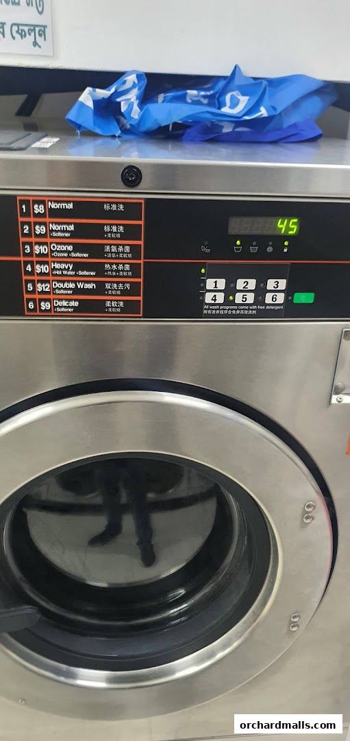 Close-up of a washing machine control panel showing wash cycle options and prices.