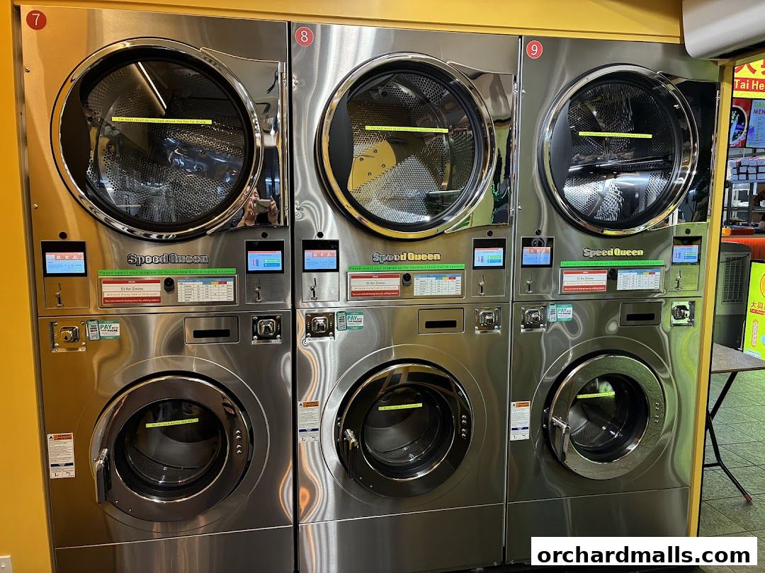 Modern Speed Queen washing machines stacked in a laundromat.