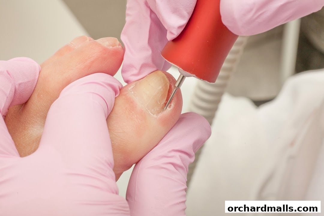 Close-up of a pedicure treatment, focusing on nail care with a rotary tool.