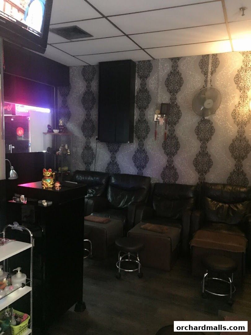 Interior of a massage parlor with comfortable chairs and decorative wallpaper.