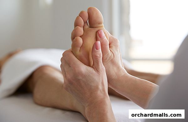 A close-up shot of a foot massage being performed by a therapist.