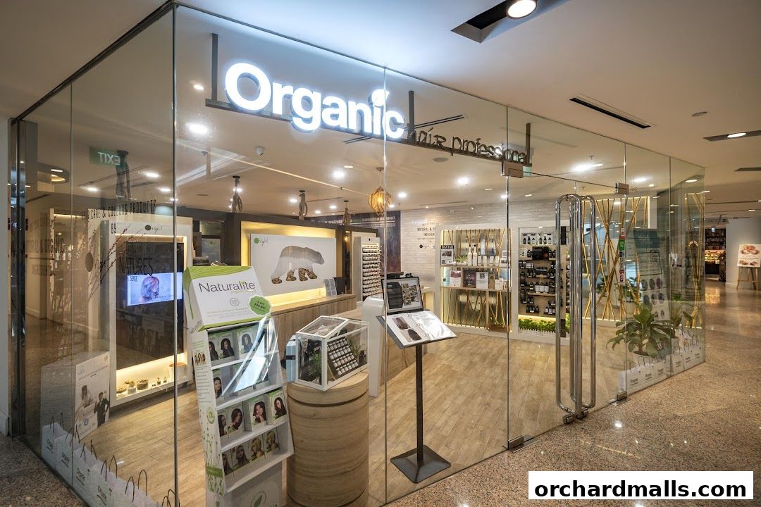 The exterior of Organic Hair Regrowth Solutions, a modern salon with glass walls showcasing products.
