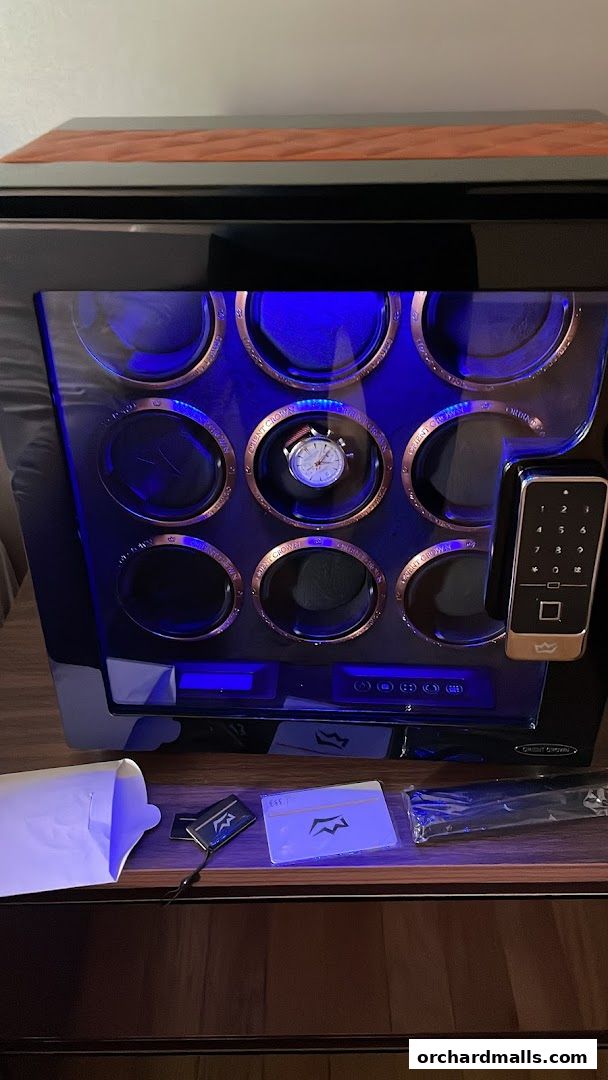 A watch winder with multiple compartments and a digital keypad.