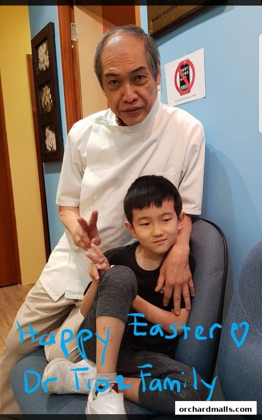 A man in a white coat and a child pose for a photo with text overlay.