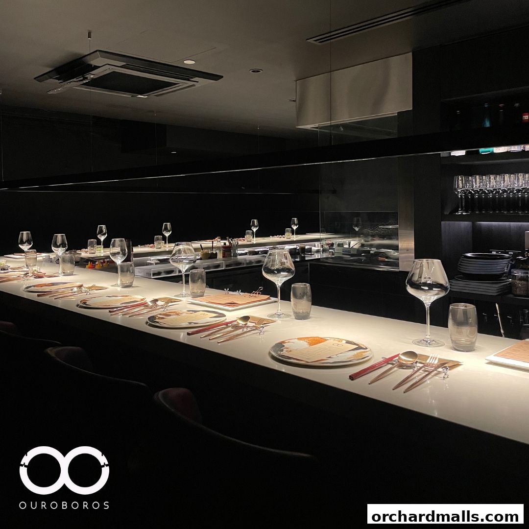 A beautifully set dining counter at OUROBOROS - Tokyo Chinese - with elegant place settings.