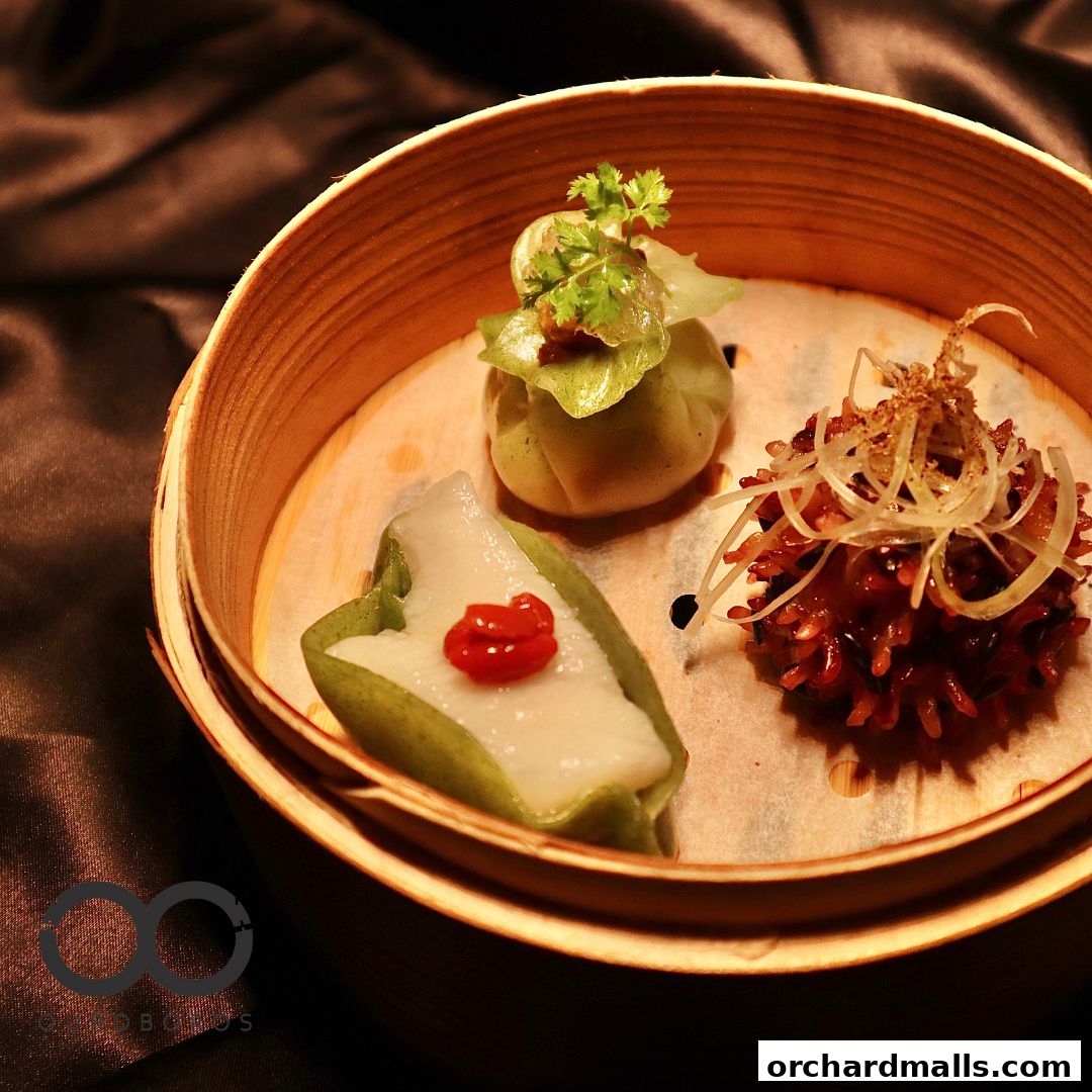 A bamboo steamer basket filled with three delicate and artfully presented dim sum dishes.
