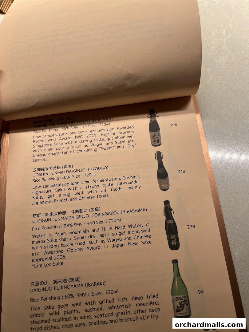 A menu page from OUROBOROS - Tokyo Chinese - featuring various sake bottles and descriptions.